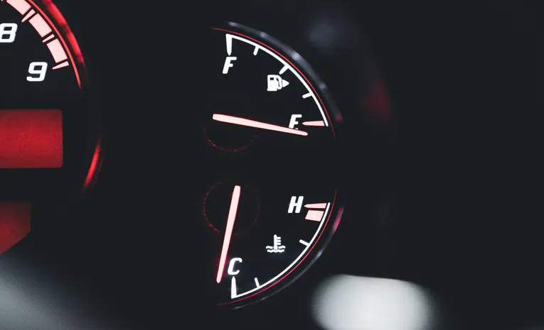 Close-up of illuminated car dashboard gauges showing warning indicators