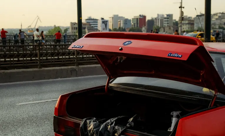 Car with open trunk on a city street showing cargo space