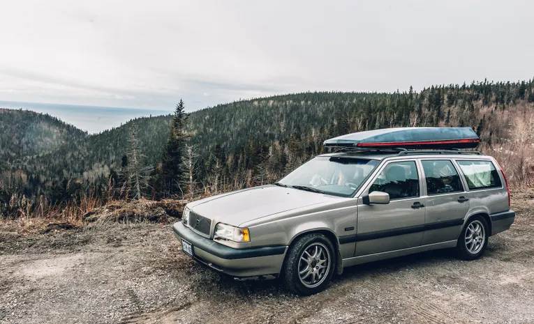 Grey estate station wagon car parked on a scenic road