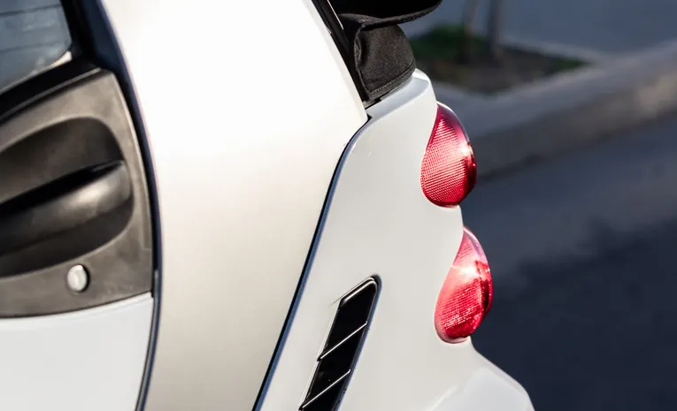 Small compact hatchback car parked on a city street