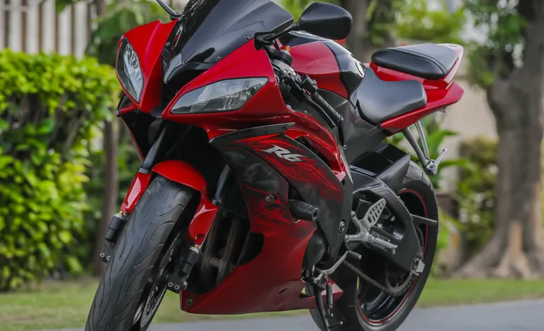 Red Yamaha sports motorcycle parked on street showing engine size class