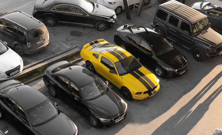 High angle view of various cars parked in a large parking lot
